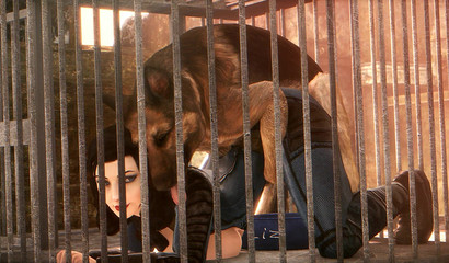 Caged brunette Elizabeth has sex with German Shephard